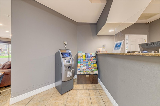 interior space featuring light tile patterned floors and washer / dryer