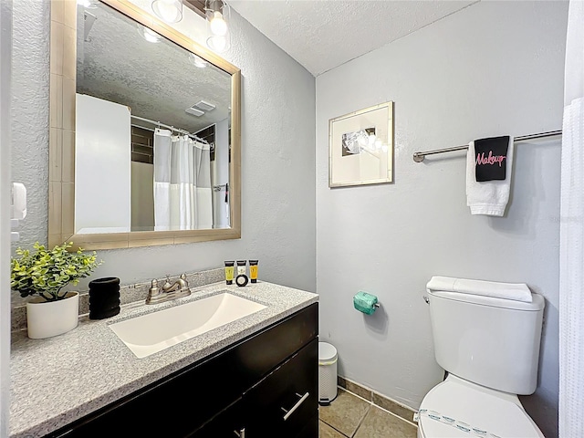 full bathroom featuring vanity, a textured wall, tile patterned flooring, a textured ceiling, and toilet
