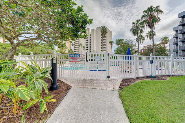 view of gate featuring a community pool and fence