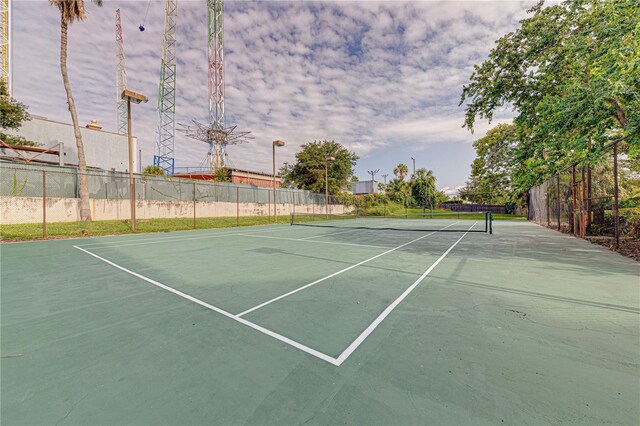 view of sport court featuring fence