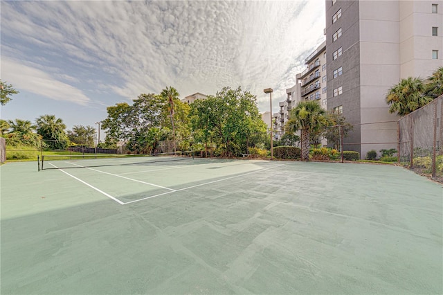 view of tennis court featuring fence