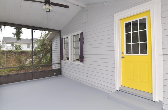 unfurnished sunroom with ceiling fan and lofted ceiling