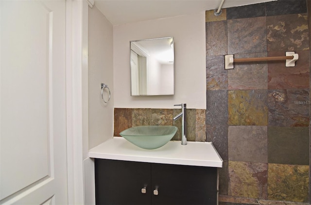 bathroom featuring vanity and tile walls