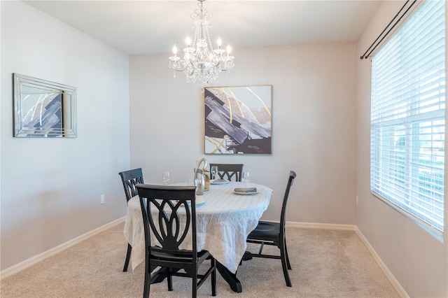 carpeted dining room featuring an inviting chandelier