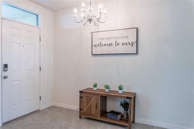 tiled entrance foyer featuring an inviting chandelier