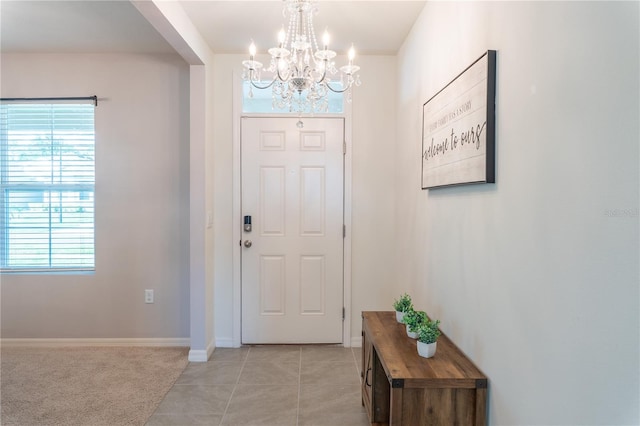 entryway featuring light tile patterned flooring and a chandelier