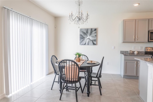 dining space featuring light tile patterned flooring and an inviting chandelier