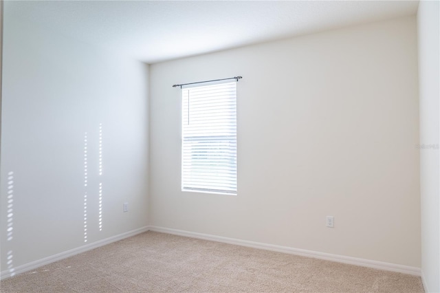 unfurnished room with light carpet