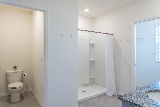 bathroom with walk in shower, vanity, toilet, and tile patterned floors