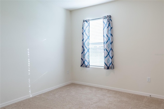 carpeted empty room featuring plenty of natural light