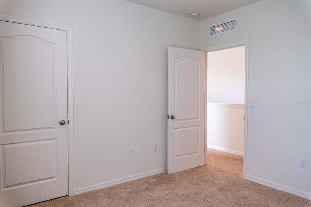 unfurnished bedroom with light colored carpet