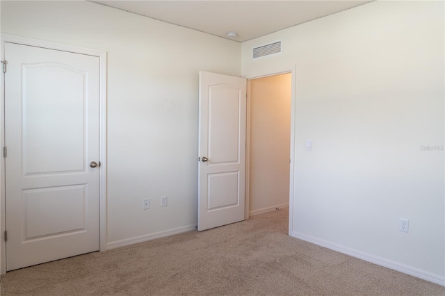 unfurnished bedroom featuring light colored carpet