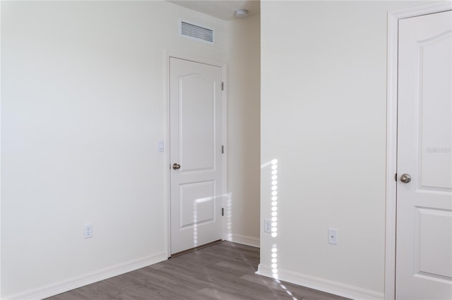 spare room with dark wood-type flooring