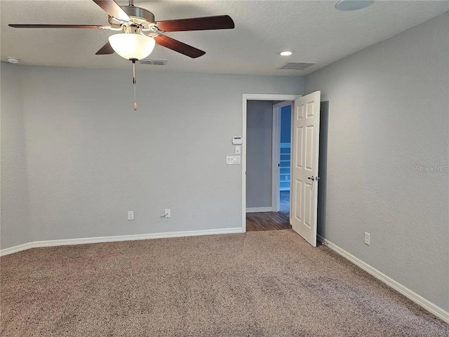 unfurnished room featuring ceiling fan and carpet