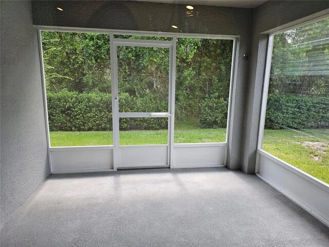 unfurnished sunroom featuring plenty of natural light