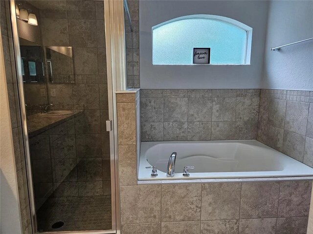 bathroom featuring sink and plus walk in shower