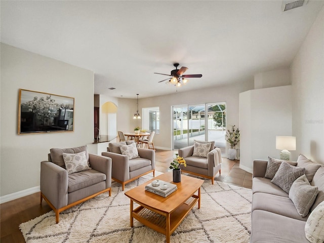 living room featuring ceiling fan and light hardwood / wood-style flooring