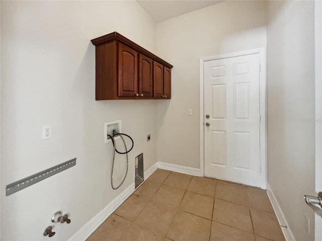 laundry room with cabinets, washer hookup, hookup for an electric dryer, gas dryer hookup, and light tile patterned floors