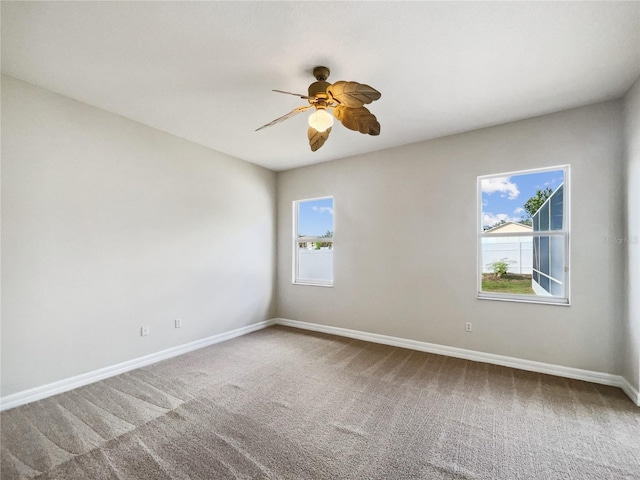 unfurnished room featuring ceiling fan, carpet flooring, and plenty of natural light