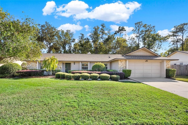 ranch-style home with a front yard and a garage