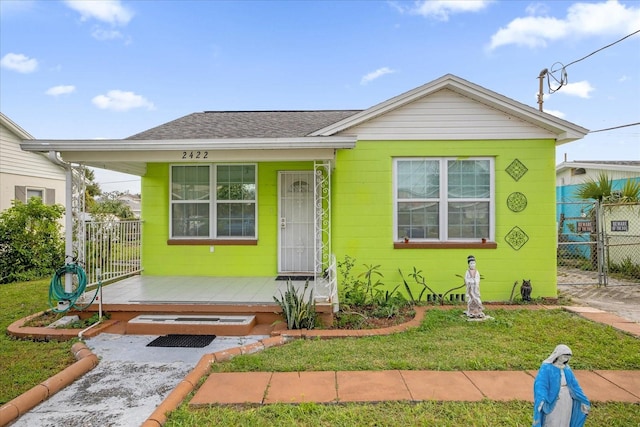 bungalow-style home with a front yard