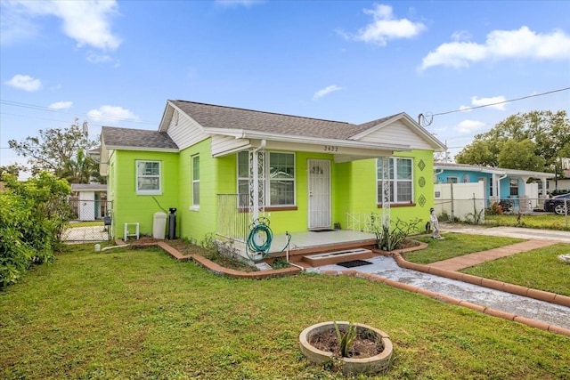 bungalow-style home with a front lawn