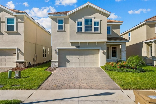 mediterranean / spanish house featuring a front lawn and a garage