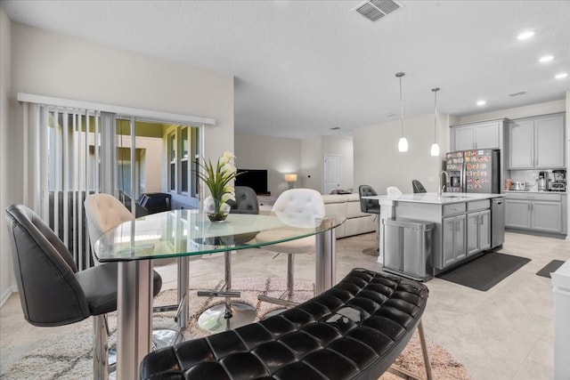 tiled dining area featuring sink