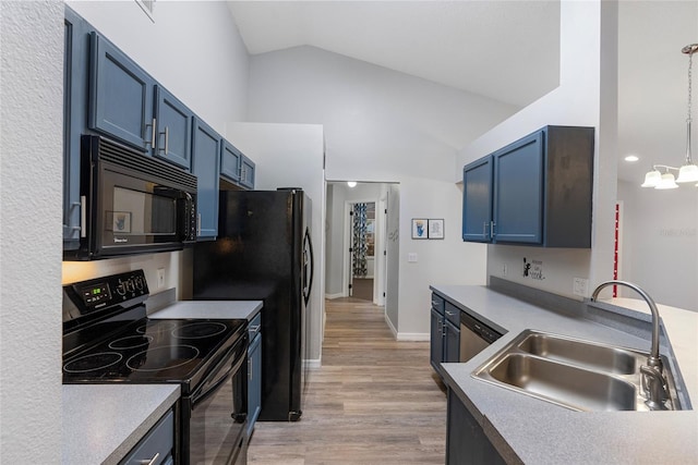 kitchen featuring black appliances, sink, blue cabinets, light hardwood / wood-style floors, and lofted ceiling