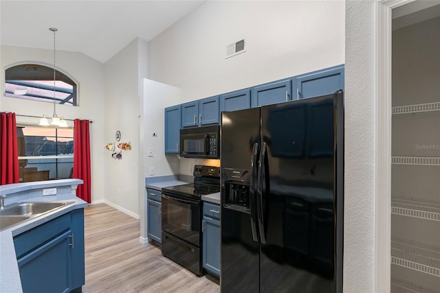 kitchen featuring sink, black appliances, light wood-type flooring, blue cabinetry, and high vaulted ceiling