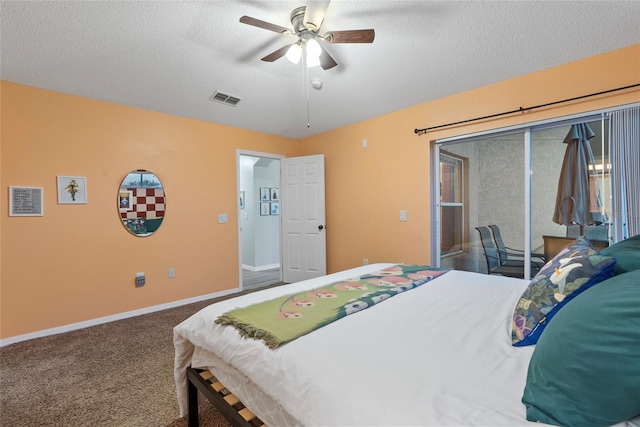 carpeted bedroom with a textured ceiling and ceiling fan