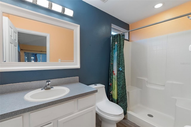 bathroom with vanity, toilet, a shower with curtain, and hardwood / wood-style floors