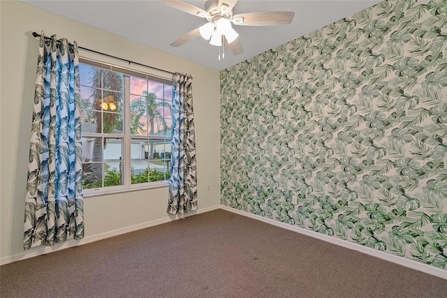 carpeted spare room with ceiling fan