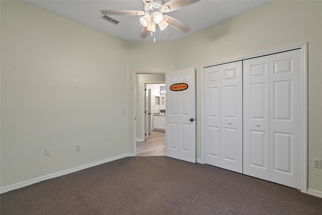 unfurnished bedroom featuring carpet flooring, a closet, and ceiling fan