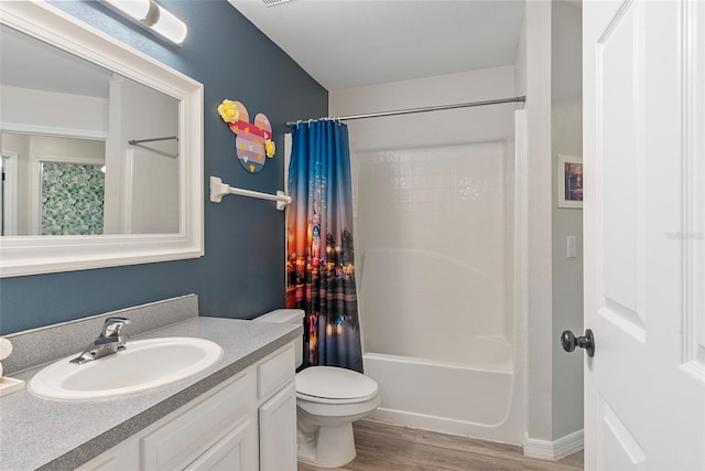 full bathroom featuring toilet, vanity, wood-type flooring, and shower / tub combo