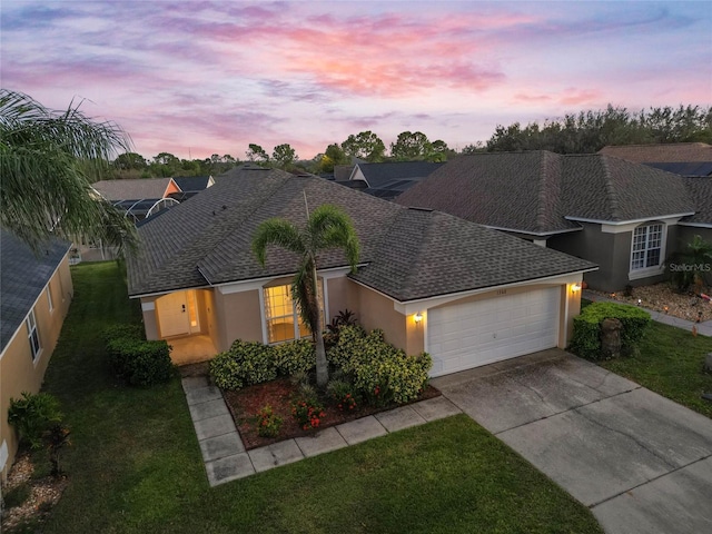 ranch-style house with a lawn and a garage