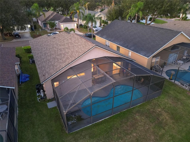 view of pool featuring a yard, a patio area, and a lanai