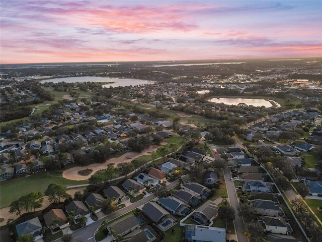 aerial view at dusk with a water view