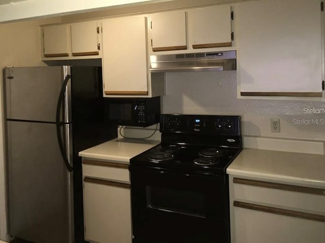 kitchen featuring stainless steel fridge and black electric range