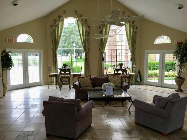 living room with french doors, high vaulted ceiling, and plenty of natural light