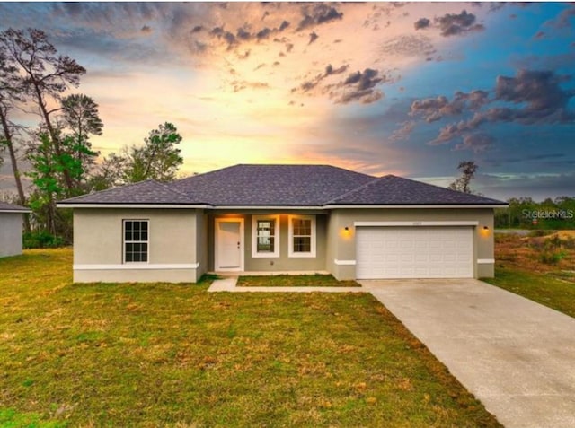 view of front of house with a yard and a garage