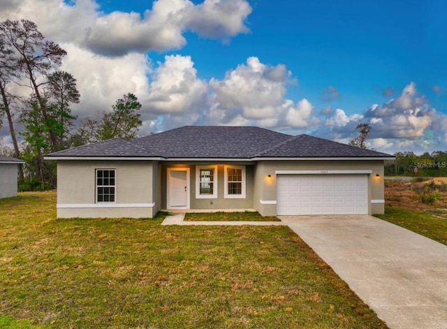 view of front of home with a front yard and a garage