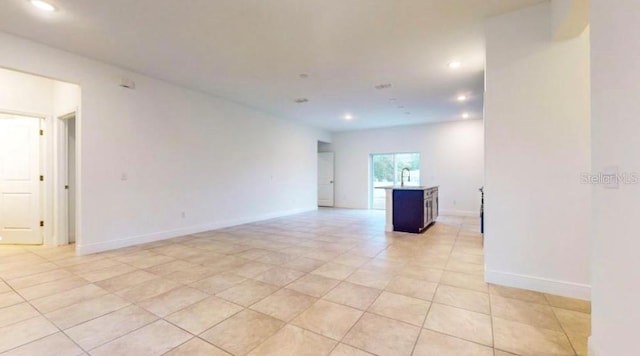 empty room featuring sink and light tile patterned floors