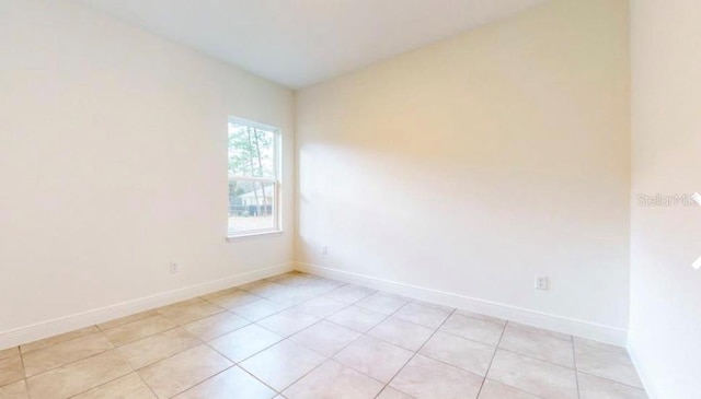 unfurnished room with light tile patterned floors