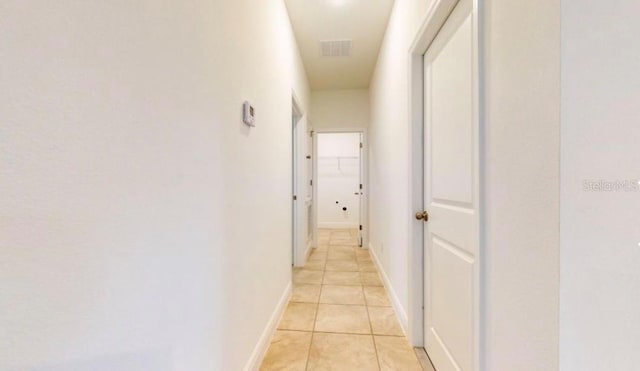 hallway featuring light tile patterned floors