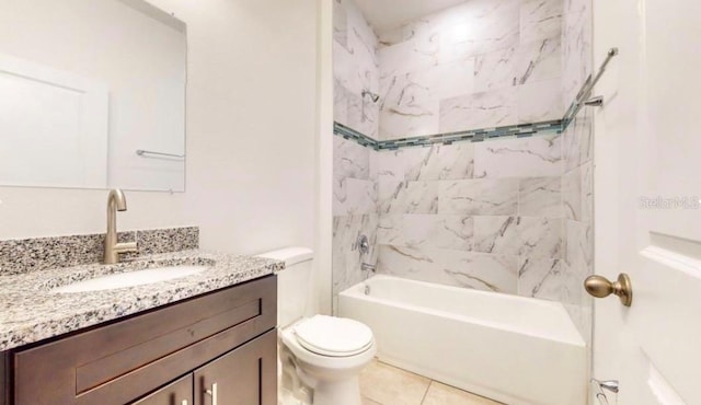 full bathroom featuring vanity, toilet, tile patterned flooring, and tiled shower / bath