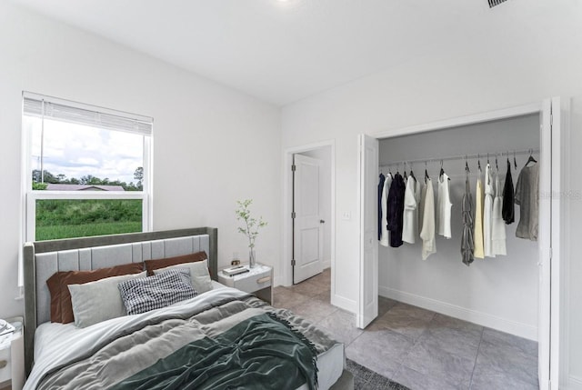 tiled bedroom featuring a closet