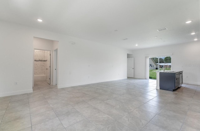 unfurnished room with light tile patterned floors