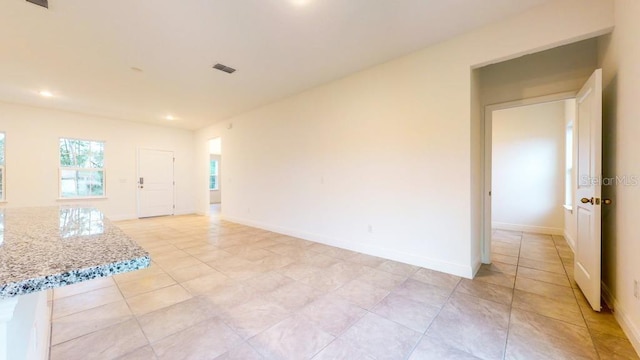 spare room with light tile patterned floors