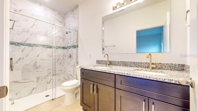 bathroom featuring vanity, a shower with shower door, toilet, and tile patterned flooring